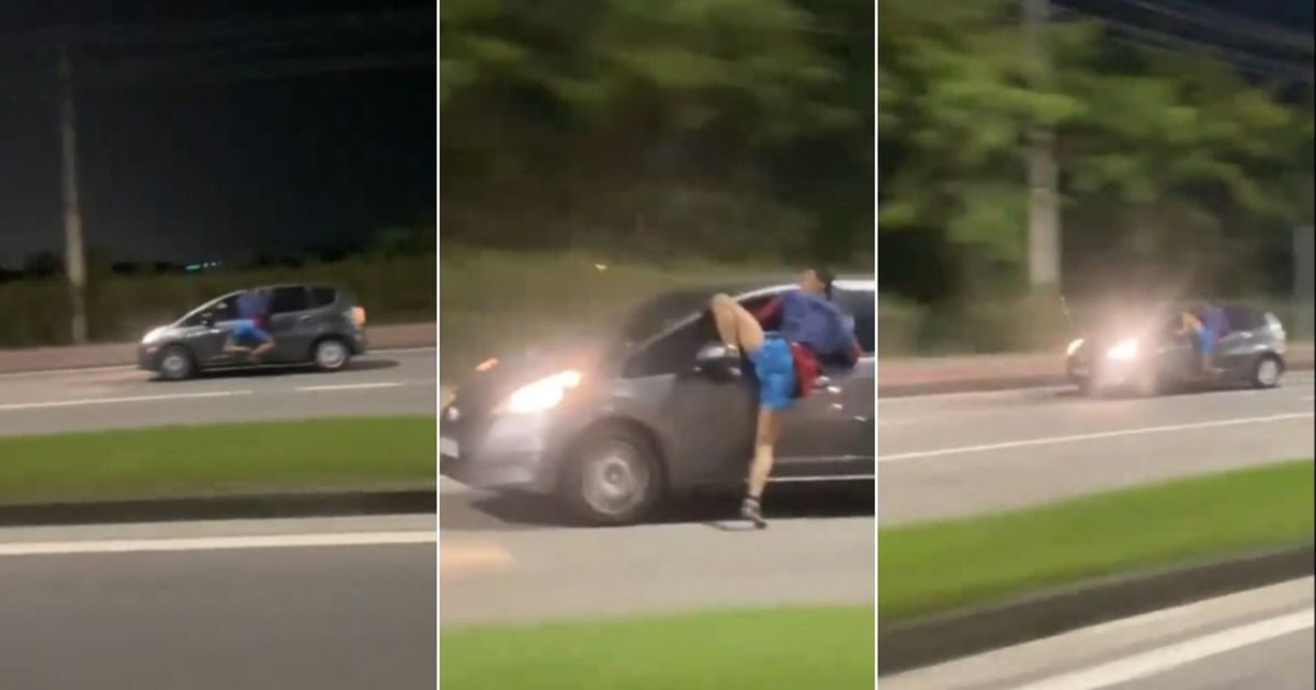 O homem pendurado na janela do carro em movimento, na Avenida Salvador Allende.