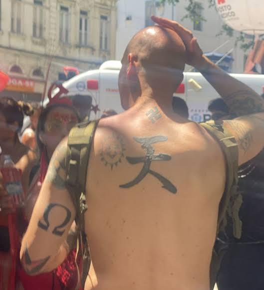 Estrangeiro com suástica tatuada.