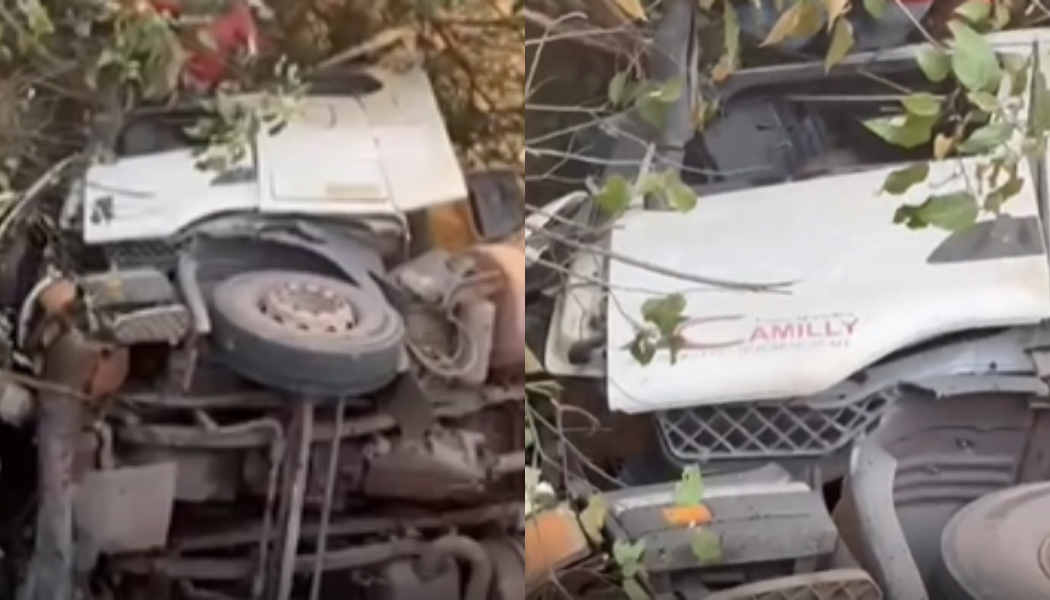 Motorista ficou preso às ferragens após o veículo atravessar a proteção e despencar da ponte; equipes de resgate atuam no local.