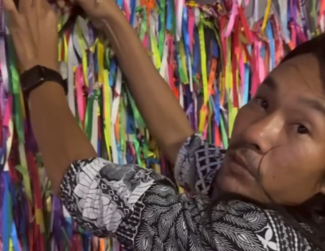 Alpinista indonésio Agam Rinjani, retira pulseira do braço e amarra na Basílica Santuário.