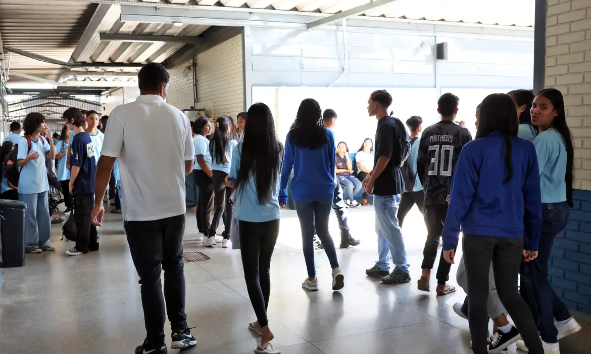 (Os beneficiados pelo programa federal são os estudantes do ensino médio matriculados na rede pública regular, entre 14 e 24 anos de idade.)