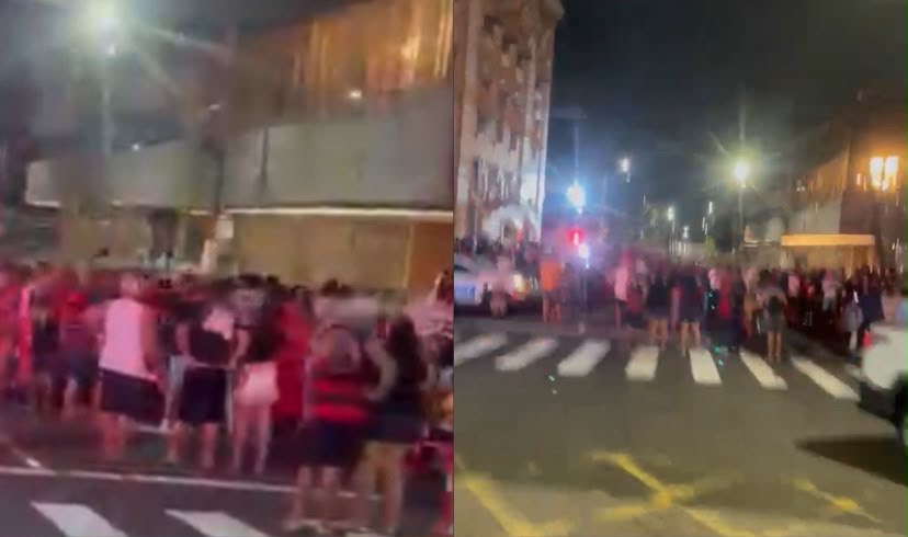 Com bandeiras, camisas, faixas e chapéus, os fãs aguardam a chegada do elenco carioca, prevista para o início da noite